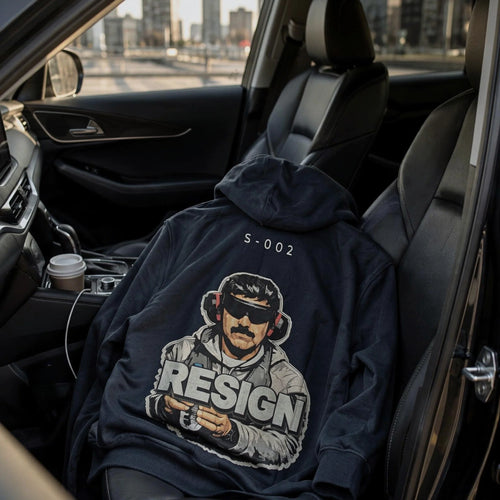 S-002 Turned Eye hoodie with S-002 code and RESIGN back graphic, displayed in a car – Kids Of Iran