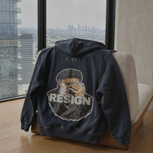 S-001 Closed Eye hoodie back with S-001 code and RESIGN graphic, displayed on a chair by a city window – Kids Of Iran